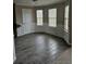 Breakfast nook featuring wood-look tiled floors, three windows and wainscotting at 165 Heaton Place Trl, Covington, GA 30016