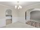 Open-concept dining room featuring decorative wainscoting, modern lighting, and seamless flow to other rooms at 165 Heaton Place Trl, Covington, GA 30016