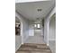 Inviting entryway featuring arched doorways, neutral paint, and new flooring at 165 Heaton Place Trl, Covington, GA 30016