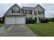 Charming two-story home featuring a two-car garage and well-manicured lawn at 165 Heaton Place Trl, Covington, GA 30016
