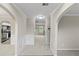 Bright hallway with archways and neutral paint, leading to various rooms in the house at 165 Heaton Place Trl, Covington, GA 30016