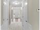 Cozy hallway featuring neutral walls, carpet, and archways, providing a welcoming feel to the home at 165 Heaton Place Trl, Covington, GA 30016