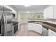 Kitchen features stainless steel appliances, countertops, and wood floors at 165 Heaton Place Trl, Covington, GA 30016