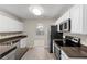 Bright kitchen features stainless steel appliances, countertops, and wood floors at 165 Heaton Place Trl, Covington, GA 30016