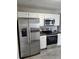 Modern kitchen featuring stainless steel appliances and white cabinets at 165 Heaton Place Trl, Covington, GA 30016