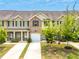 Inviting townhomes with manicured lawns, individual driveways, and charming architectural details at 1931 Old Dogwood, Jonesboro, GA 30238