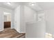 Upstairs hallway featuring wood floors and access to bedrooms and bath at 1931 Old Dogwood, Jonesboro, GA 30238