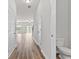 Inviting hallway with wood floors leading to brightly lit living area and half bath at 1931 Old Dogwood, Jonesboro, GA 30238