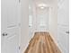 Hallway with wood-look floors, white doors, and a view to the exterior at 1931 Old Dogwood, Jonesboro, GA 30238