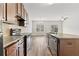 Kitchen area with a view to the dining space and stainless steel dishwasher at 1931 Old Dogwood, Jonesboro, GA 30238