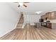 An open-concept design of the staircase, kitchen, and living room with natural light at 1931 Old Dogwood, Jonesboro, GA 30238
