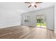 Bright living room featuring a modern ceiling fan, chandelier, and sliding glass doors at 1931 Old Dogwood, Jonesboro, GA 30238