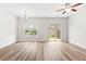 Bright living room featuring a modern ceiling fan, chandelier, and sliding glass doors at 1931 Old Dogwood, Jonesboro, GA 30238