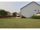 Expansive backyard with lush green grass, fenced-in area, patio, and swing set for outdoor enjoyment at 2029 Havenhurst Way, Auburn, GA 30011