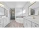 Elegant bathroom with dual sinks, a separate tub and a glass-enclosed shower at 2029 Havenhurst Way, Auburn, GA 30011