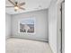Bright bedroom features a ceiling fan, a window, and neutral walls, offering a cozy atmosphere at 2029 Havenhurst Way, Auburn, GA 30011