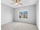 Bright bedroom features a ceiling fan, a window, and neutral walls, offering a cozy atmosphere at 2029 Havenhurst Way, Auburn, GA 30011