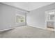 Spacious bedroom with an ensuite bathroom, neutral paint and carpet, and a window to the outside at 2029 Havenhurst Way, Auburn, GA 30011