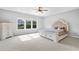 Bright bedroom features a large window, plush carpeting and simple decor at 2029 Havenhurst Way, Auburn, GA 30011