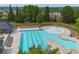 Aerial view of a sparkling community pool with lounge chairs and well-maintained landscaping at 2029 Havenhurst Way, Auburn, GA 30011
