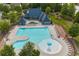 Inviting community pool area with ample seating, a splash zone, and a clubhouse at 2029 Havenhurst Way, Auburn, GA 30011