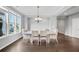 Airy dining room with hardwood floors, a modern chandelier, and large windows providing ample natural light at 2029 Havenhurst Way, Auburn, GA 30011