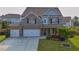 Charming two-story home featuring a brick and stone facade, a two-car garage, and a well-manicured front yard at 2029 Havenhurst Way, Auburn, GA 30011