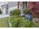 Close up on well landscaped yard with flowers and shrubs, and a view of the home's exterior and two car garage at 2029 Havenhurst Way, Auburn, GA 30011