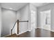 Bright second-floor hallway with wood floors and white stair railing at 2029 Havenhurst Way, Auburn, GA 30011