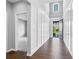 Inviting foyer with hardwood floors, white wainscoting, and a glimpse of the front door, and view to a carpeted room at 2029 Havenhurst Way, Auburn, GA 30011