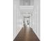 Elegant hallway with hardwood floors, white wainscoting, and views into a living room at 2029 Havenhurst Way, Auburn, GA 30011