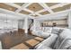 Spacious living room featuring hardwood floors, a coffered ceiling, and an open layout to the kitchen and dining area at 2029 Havenhurst Way, Auburn, GA 30011