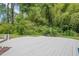 A serene backyard with lush greenery and a deck, perfect for relaxation and entertaining at 205 Plantation Sw Rd, Smyrna, GA 30082