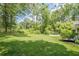 Expansive backyard featuring lush green lawn, mature trees, and a serene natural setting at 205 Plantation Sw Rd, Smyrna, GA 30082