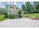 Exterior shot of the home, showcasing a spacious backyard with a deck and lush landscaping at 205 Plantation Sw Rd, Smyrna, GA 30082