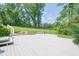 Backyard features a spacious white deck area surrounded by lush greenery and a large lawn at 205 Plantation Sw Rd, Smyrna, GA 30082