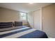 Cozy bedroom with a comfortable striped bed and a window with natural light at 205 Plantation Sw Rd, Smyrna, GA 30082
