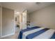 Cozy bedroom featuring a blue-and-white striped bedspread and access to an adjoining bathroom at 205 Plantation Sw Rd, Smyrna, GA 30082