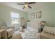 Charming Bedroom with a window, neutral walls and ceiling fan, and a cozy seating area at 205 Plantation Sw Rd, Smyrna, GA 30082
