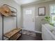 Entryway featuring coat rack, modern decor, and hardwood floors, creating a warm and inviting ambiance at 205 Plantation Sw Rd, Smyrna, GA 30082