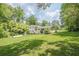 A beautiful home with a lush green lawn, an attached carport, and mature shade trees at 205 Plantation Sw Rd, Smyrna, GA 30082