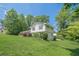 The home boasts a lush green lawn, mature landscaping, and dark shuttered windows at 205 Plantation Sw Rd, Smyrna, GA 30082