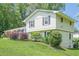 Beautiful home with dark shutters, a colorful front garden, and mature landscaping at 205 Plantation Sw Rd, Smyrna, GA 30082