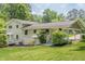 Charming home exterior with a covered entrance, lush landscaping, and a well-maintained lawn at 205 Plantation Sw Rd, Smyrna, GA 30082