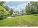 A beautiful home with a lush green lawn, an attached carport, and mature shade trees at 205 Plantation Sw Rd, Smyrna, GA 30082