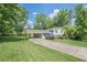 Charming two-story home with a welcoming carport and nicely landscaped front yard at 205 Plantation Sw Rd, Smyrna, GA 30082