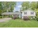 Charming split-level home featuring a manicured lawn, bright blue door, and covered carport, inviting you to call it home at 205 Plantation Sw Rd, Smyrna, GA 30082