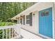 Close up of a charming front porch with a bright blue front door, offering a warm and welcoming curb appeal at 205 Plantation Sw Rd, Smyrna, GA 30082