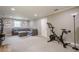 Inviting living room with a gray sofa, ottoman, and a stationary bike for exercise at 205 Plantation Sw Rd, Smyrna, GA 30082