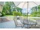 Outdoor patio with a table, chairs, grill, and view of the expansive green lawn at 205 Plantation Sw Rd, Smyrna, GA 30082